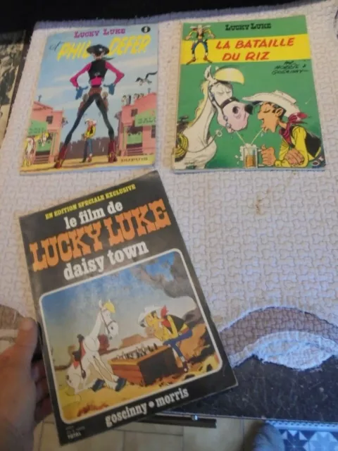 Albums Souples Lucky Luke Lot de 3 Phil Defer,Daisy Town & Bataille du Riz Total