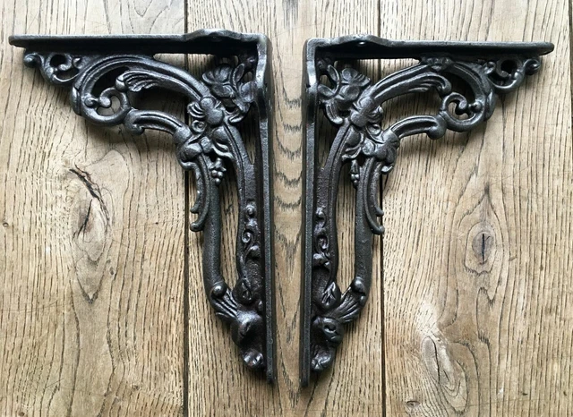A pair of cast iron Victorian style foliage shelf brackets shelving cistern
