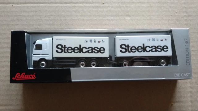 Schuco 23651 – Camion MB Actros V8 Surbaissé Avec Pelleteuse – 1/87 – Occasion