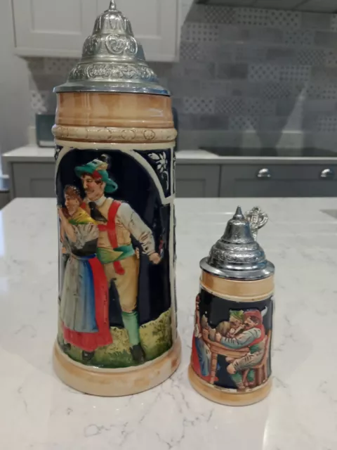 West German Pair Of Steins With Metal / Pewter Lids 1 is 11.5" tall Other 6"