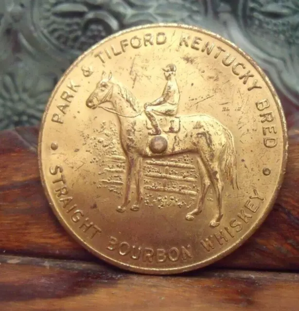 Park Tilford Kentucky Bred Bourbon Whiskey Spinner Token Horse Jockey Horseshoe