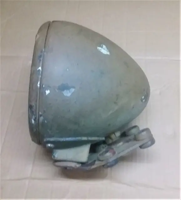 Dodge M37 truck headlight housing. Used. As shown with its brucket. Needs care.