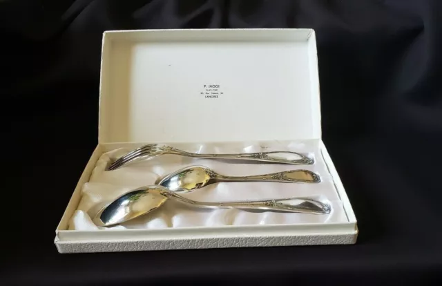 Ensemble de 3 couverts de style Louis XV en métal argenté dans son écrin.
