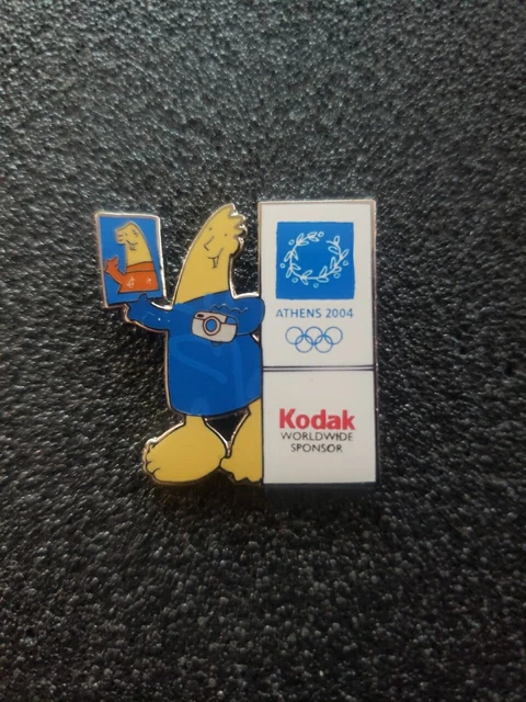 Pin's Kodak – Jeux Olympiques, Version Ski, époxy Fond Doré. Un Petit Bout D'histoire Olympique !