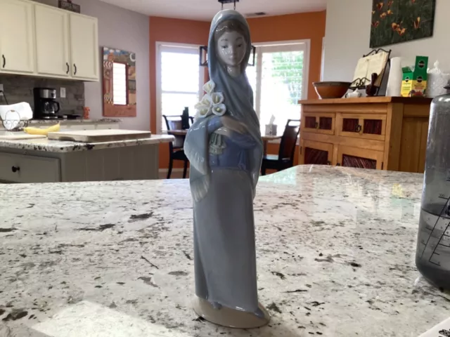 Lladro, Girl with Lillie’s, 9.5 inches tall, no box