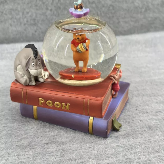 DISNEY STORE- Small Winnie The Pooh on Books and Eeyore Snow Globe Figurine (OR)