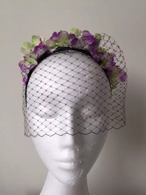 Flowered headband fascinator with netting. Stunning on!