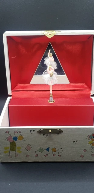 Jewelry music box with whimsical hand painted figures. Red silk material inside.