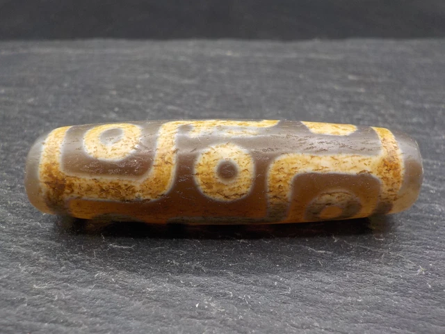 An Agate Dzi bead with a 9 Eye pattern from Tibet / Nepal. Tibetan Dzi Bead.