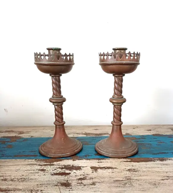 A pair of late 19th century Gothic revival copper and brass candlestick holders