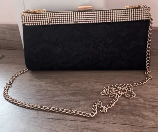 Roland cartier sales silver clutch bag