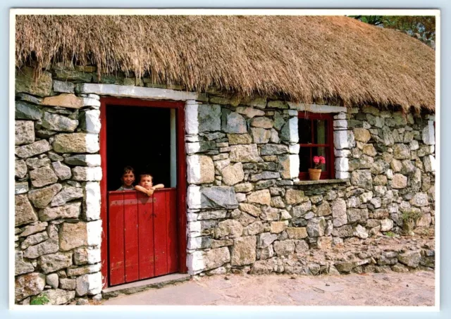 An Irish Cottage children looking through door Ireland 4x6 Postcard