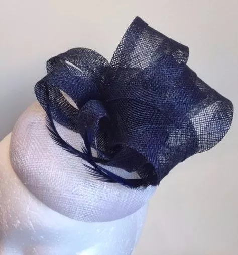 Stunning white button base fascinator with navy blue loops and feathers!