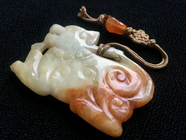 A Chinese celadon and russet jade pendant, 19th/20th century hand carved Foo Dog 3
