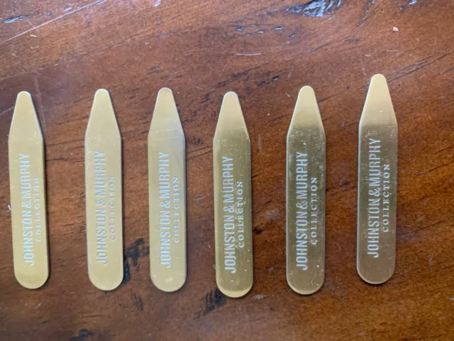 Six metal Johnston and Murphy collar stays; brass color