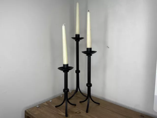 Three matching black metal tapered gothic indoor tall candle stick holders