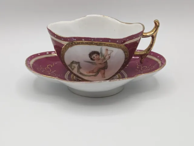 Dresden Style Hand Painted Cherubs Cranberry Gold Quatrefoil Tea Cup & Saucer