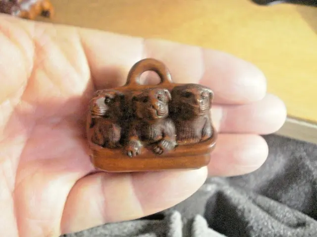 Hand Carved wood netsuke 3 puppy dogs in a bag, collectable boxwood figure