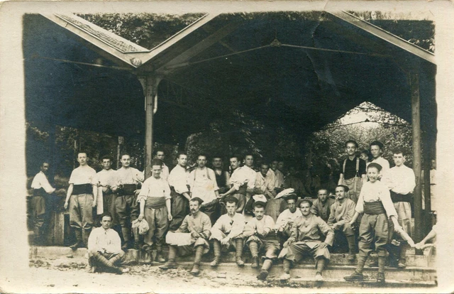 Military Soldier Photo Card Including a Boy Smoking Pipe Under a Shelter