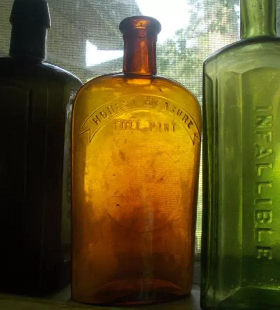 AMBER HONEST MEASURE FULL PINT 1890s STRAP SIDE WHISKEY FLASK HAND BLOWN