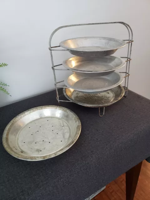 Pie Pans - New England Table talk Flaky Crust with wire stand and other pans.