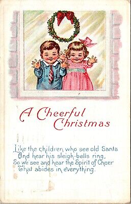 A Cheerful Christmas Children At Window Wreath c1924 Embossed Postcard
