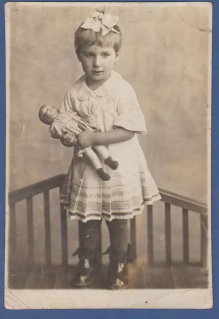 Beautiful Girl with bow with a doll on the bed, Cute Baby Soviet Vintage Photo