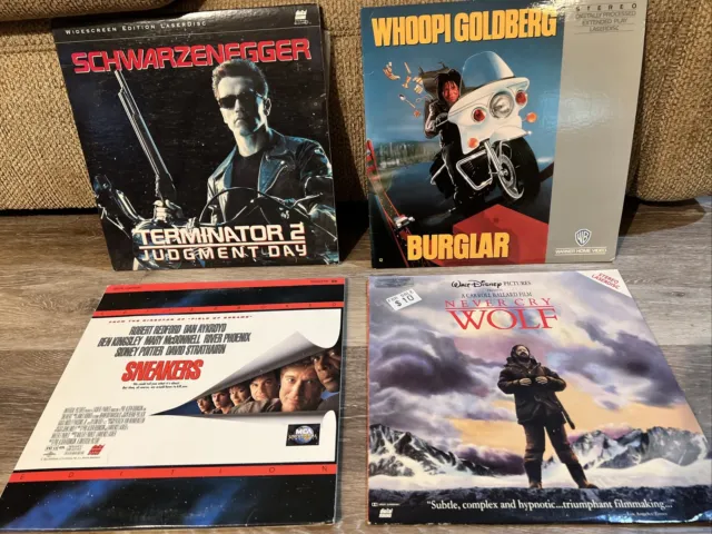 Lot of 4 Laserdiscs: TERMINATOR 2, SNEAKERS, NEVER CRY WOLF and BURGLAR