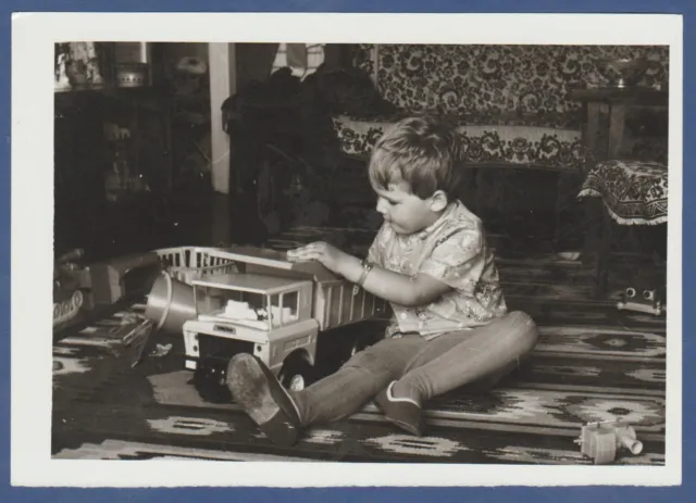 Beautiful Boy playing with a children's car. Soviet Vintage Photo USSR