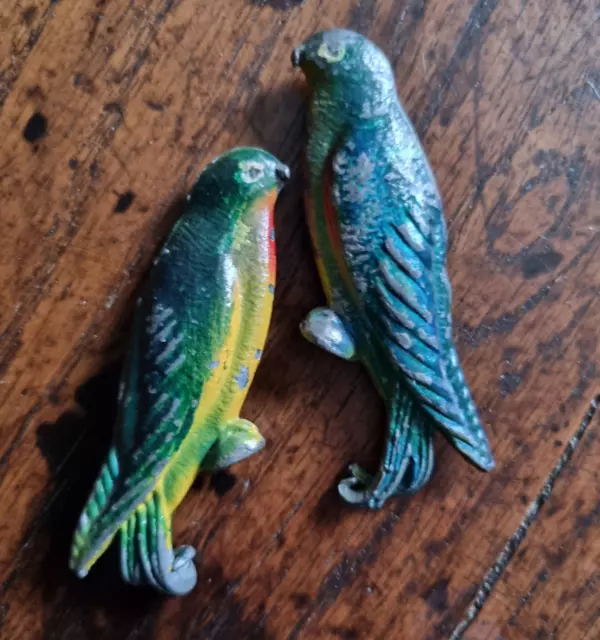 Pair of old miniature possibly balancing parrots, cold painted metal, antique
