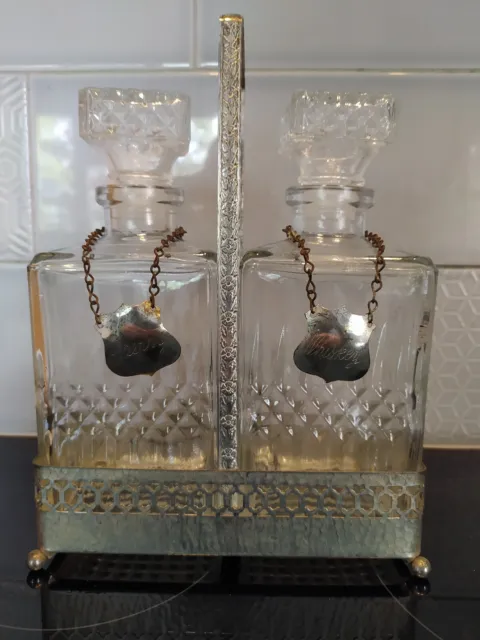 PAIR of GLASS DECANTERS in SILVER METAL STAND