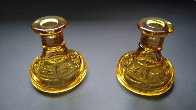 Pair of Vintage Amber coloured glass candlesticks.