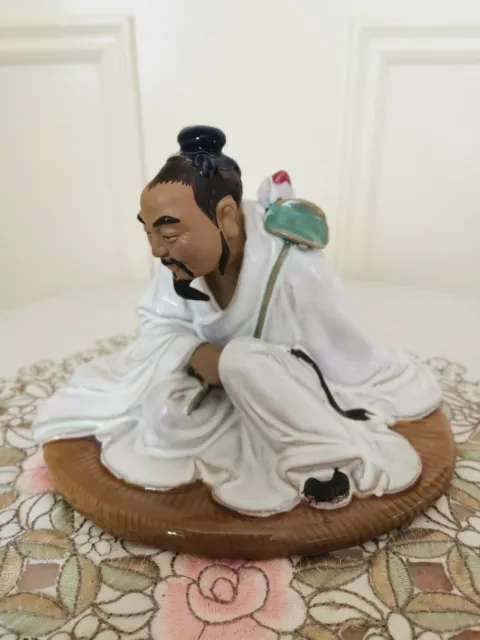 Shiwan Clay Glazed Mudman Seated Man in White Robe with Lotus Flower
