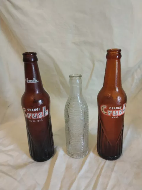 TWO VINTAGE ORANGE CRUSH SODA BOTTLES  Amber Brown 12oz And One Clear Bottle
