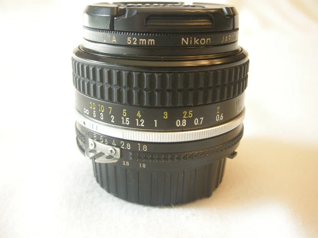 Nikon Nikkor 50mm f1.8 lens with a Nikon L1A 52mm filter and OEM caps