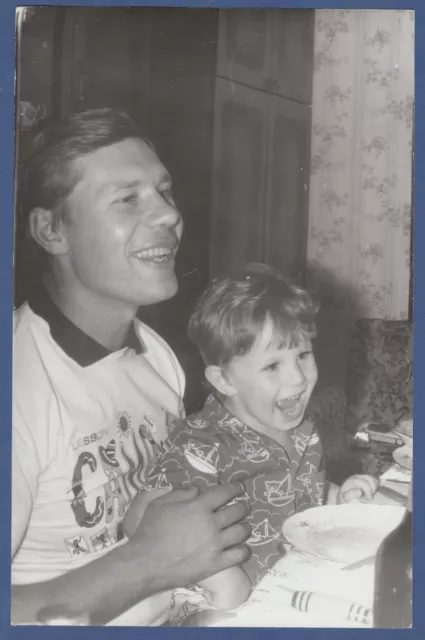 Boy and son laughing merrily at the table. Soviet Vintage Photo USSR