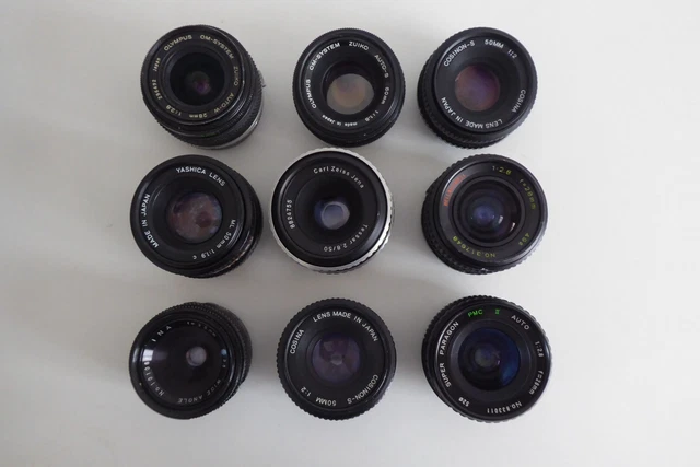 9 LENTES DE CÁMARA surtidos Inc. Olympus, Yashica y Carl Zeiss. Lote de trabajo