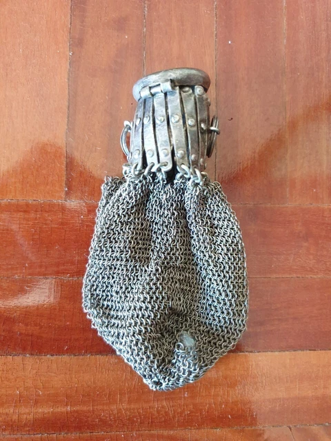 Old wallet. Possibly made of silver.
