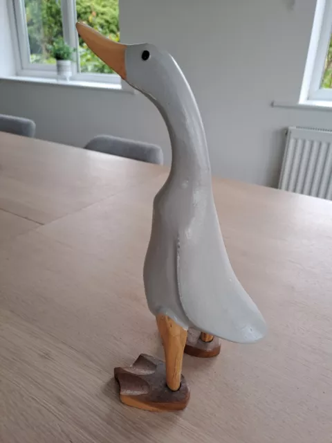 Grey wooden duck with brown legs, feet and beak, approximately 28 cm tall