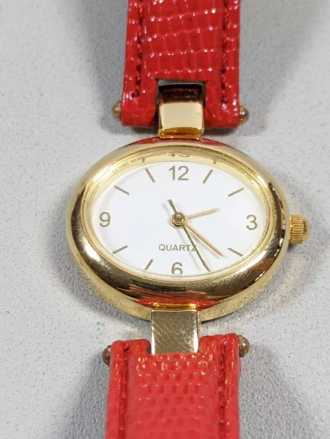 White Dial Oval Gold Tone Case Red Leather Band Watch