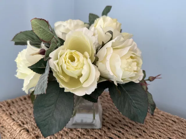 White Rose Artificial Silk Flower Arrangement In Square Glass Vase. 7 flowers