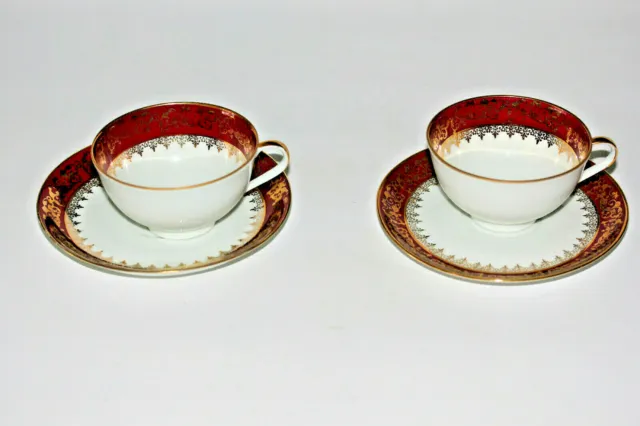 2 Tasses à café et soucoupes en porcelaine de Limoges rouge et or