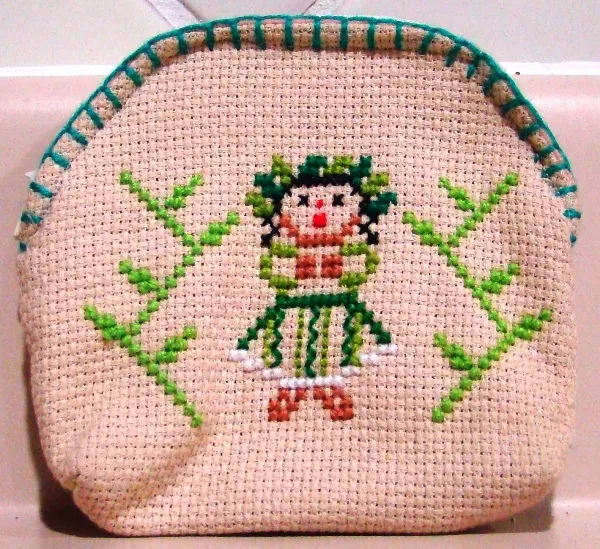 Embroidered coin purse with Otomi doll and green designs from Querétaro, Mexico