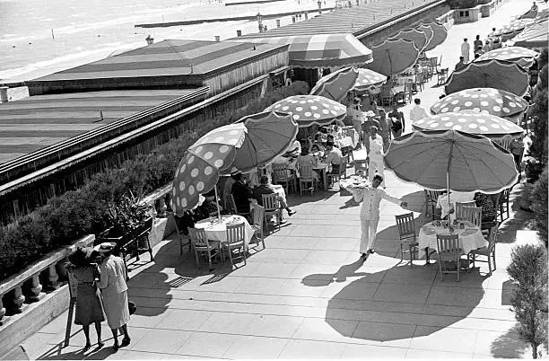 Large umbrellas provide shade outdoor tables beach cafe Miami Old Photo