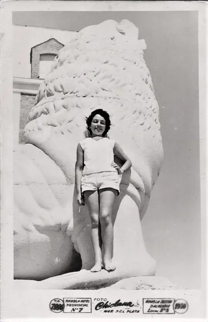 3163 Cute girl in shorts next to  lion of sea monument at the beach Photo 1956