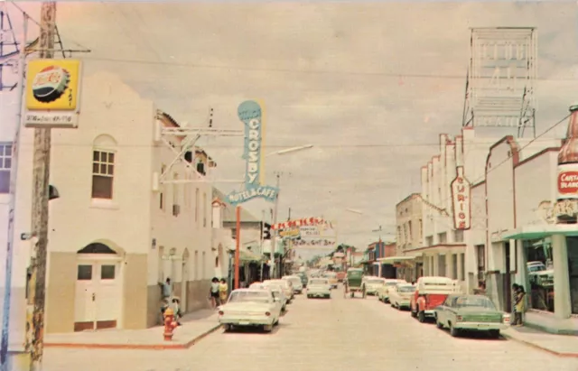 C. 1960's Acuna, Mexico Street Scene Old Cars, Vintage Pepsi-cola Sign Postcard