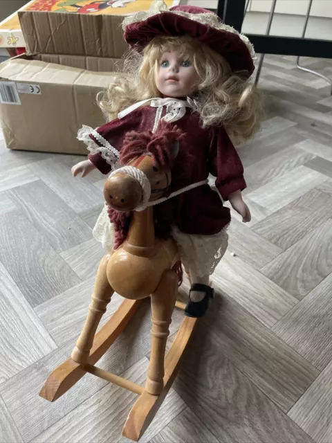 Porcelain doll cheap on rocking horse
