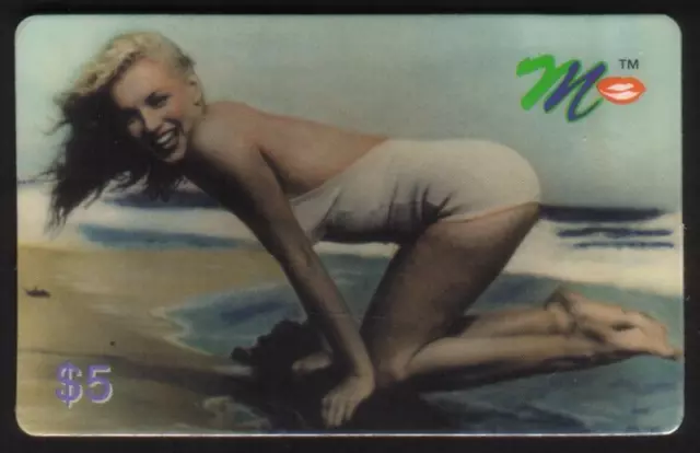 $5. Marilyn Monroe Kneeling On Driftwood In White Swimsuit On Beach Phone Card