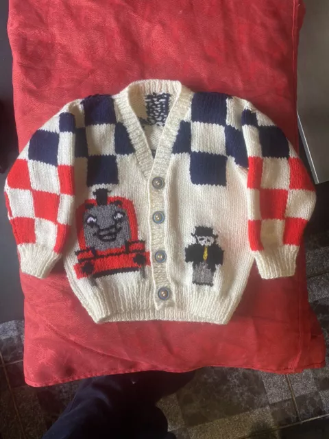 James 2-3  years, knitted in Aran wool with print on the back