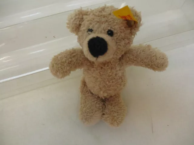 x-76461	Steiff Teddy Bär Fynn L:ca. 120mm mit Knopf und Fahne